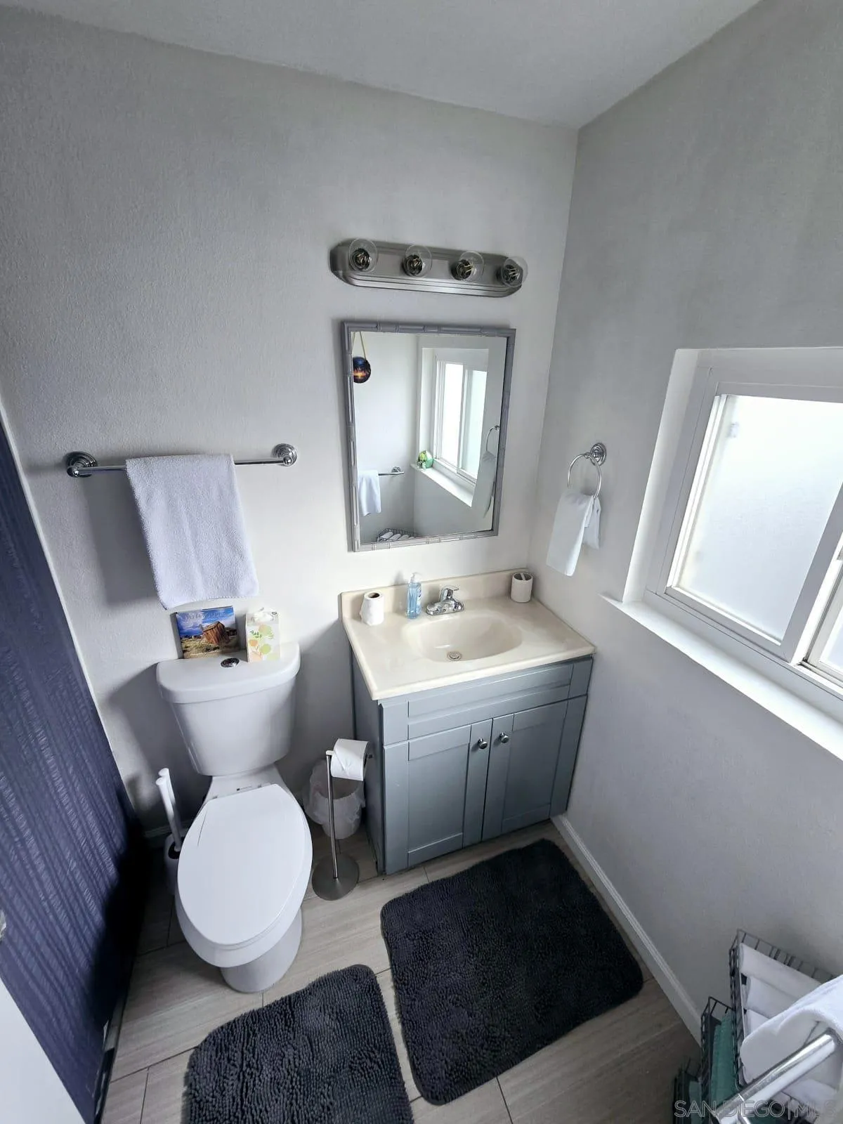 6333 Mt Ada Road, Unit 168 San Diego, CA 92111 - Photo 6 of 23 a bathroom with a sink toilet and mirror