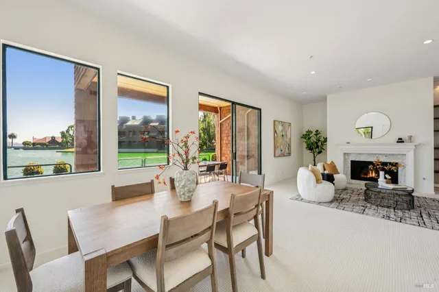 a dining room with furniture and front door
