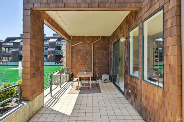 a dining room with furniture and a floor to ceiling window
