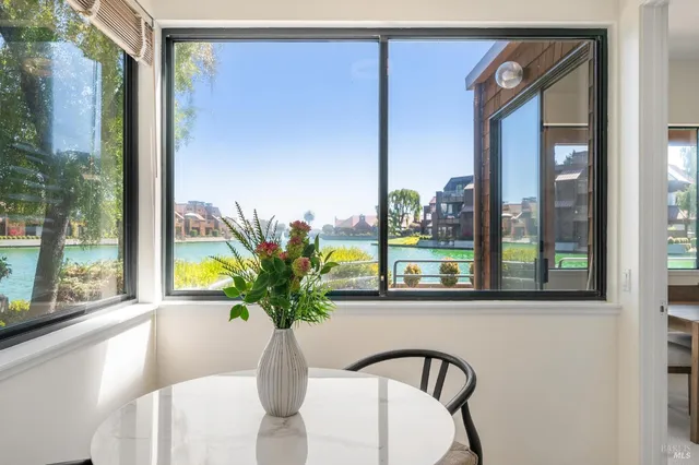 a dining room with furniture and a window