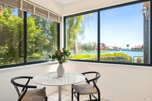 a kitchen with white cabinets appliances and sink