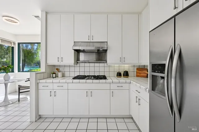 a spacious bedroom with a bed and large mirror