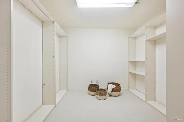 a bedroom with a bed a table and a large mirror