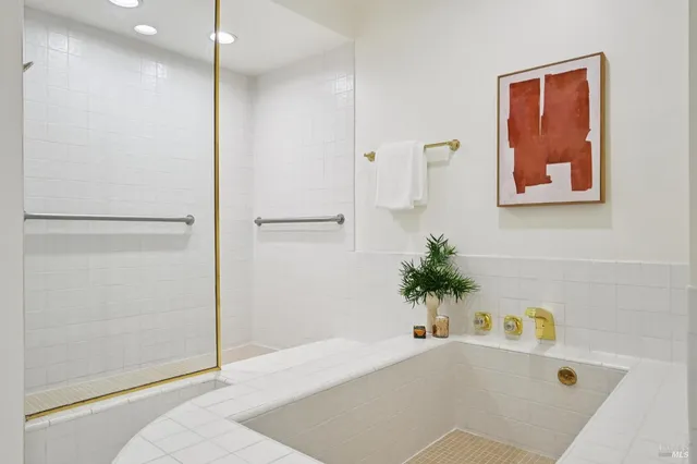 a bathroom with a tub and a shower
