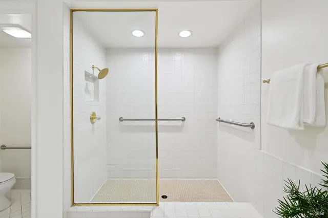 a bathroom with a sink toilet and shower