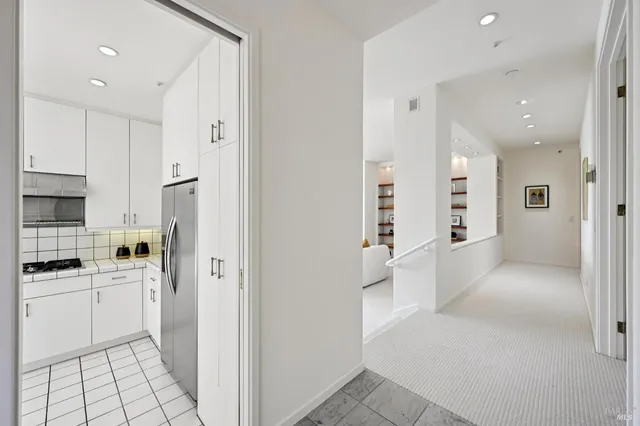 a living room with furniture a fireplace and a potted plant