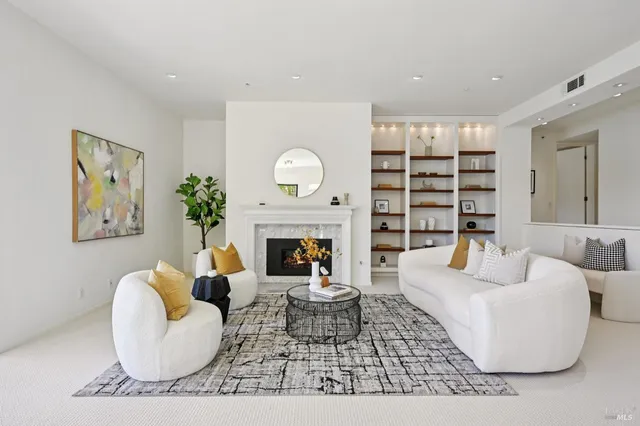 a living room with furniture and a book shelf