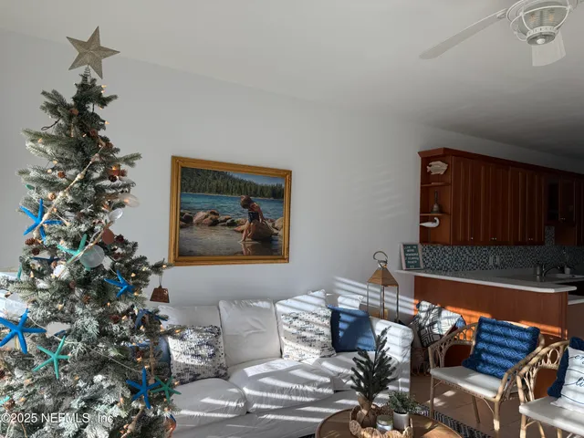 a living room with furniture and a potted plant
