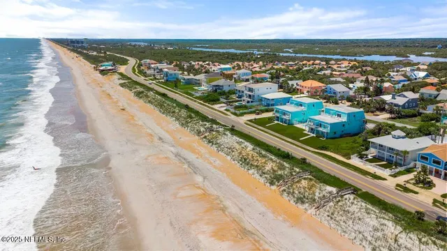 a view of yard with a car parked in front of it