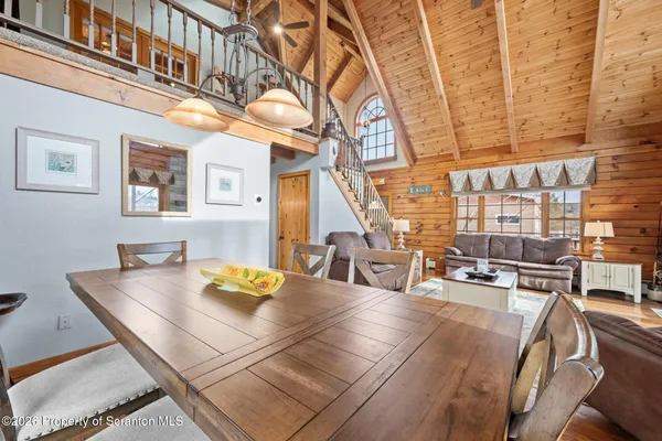 a dining room with furniture window and wooden floor