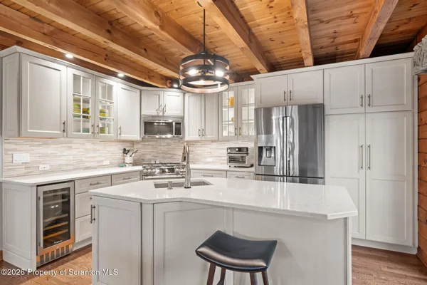 a dining room with furniture wooden floor and a rug