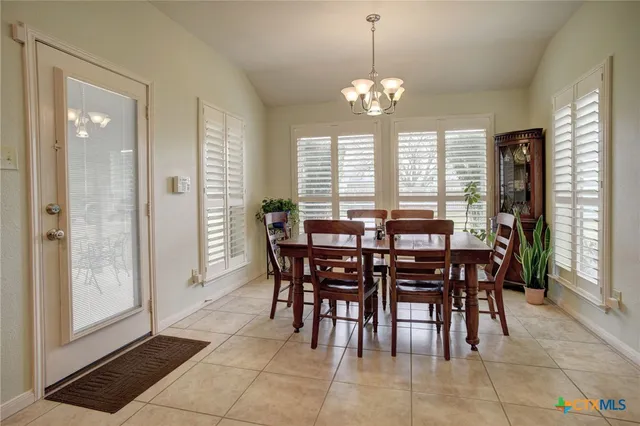 a view of a dining room with furniture and window