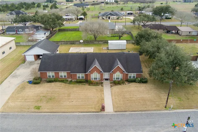 an aerial view of residential houses with outdoor space and swimming pool