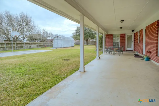 a view of a house with backyard and porch