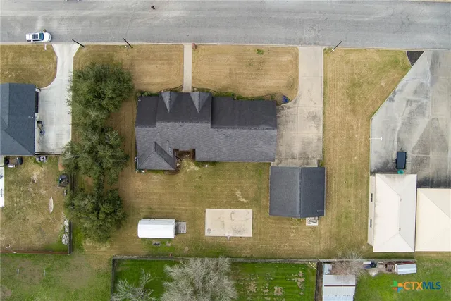 an aerial view of houses with swimming pool