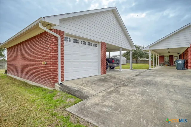 a view of a house with a backyard and a garage