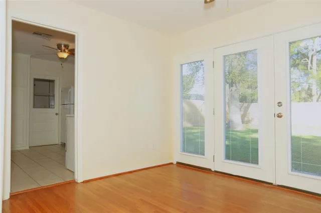 a view of an empty room with glass door and glass door