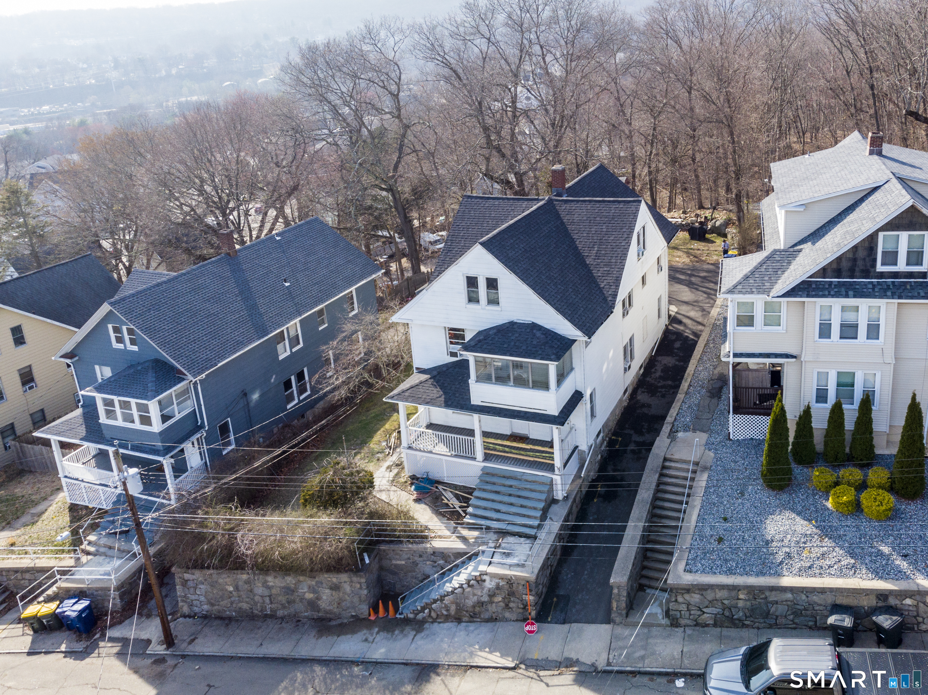 19-21 Ells Street Ansonia, CT 06401 - Photo 14 of 15 a view of a house with wooden deck stairs and furniture
