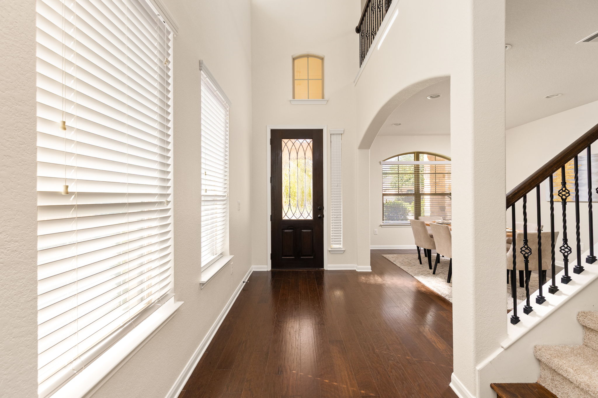 2400 Leonards Pass Leander, TX 78641 - Photo 4 of 40 A grand entry showcases soaring ceilings, rich hardwood flooring, and an elegant staircase.