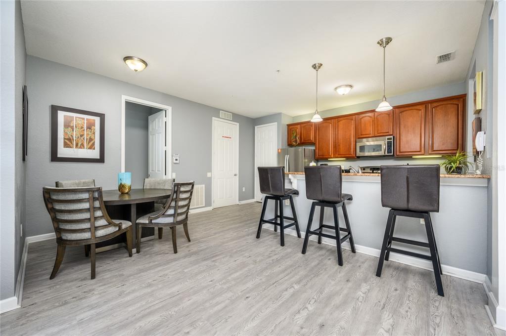 5012 Shoreway Loop, Unit 20507 Orlando, FL 32819 - Photo 12 of 49 a view of a dining room with furniture window and wooden floor
