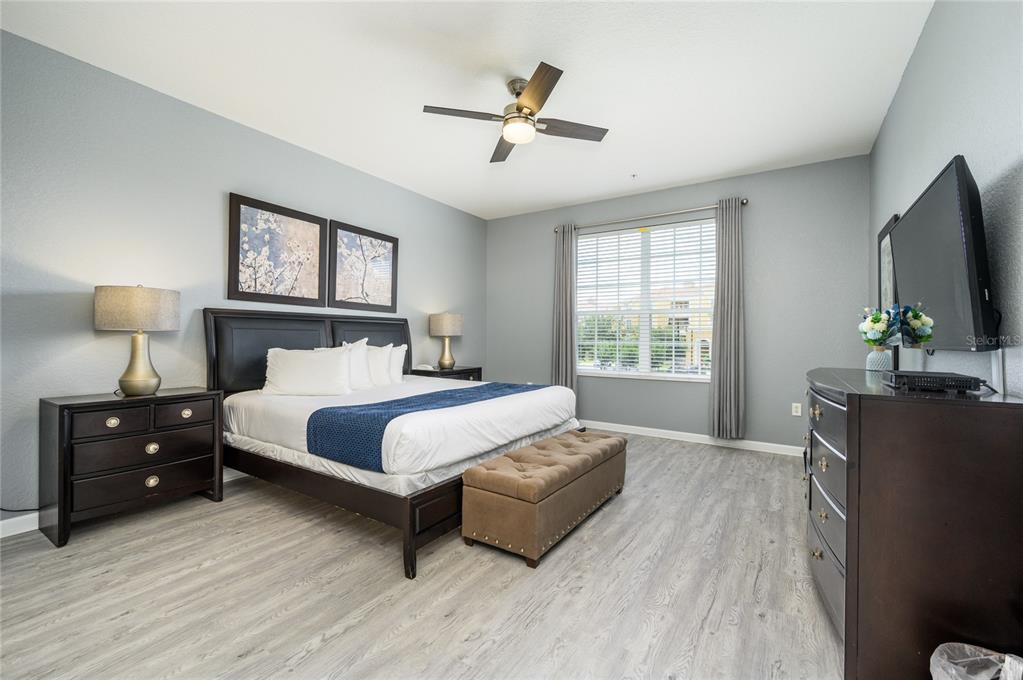 5012 Shoreway Loop, Unit 20507 Orlando, FL 32819 - Photo 17 of 49 a bedroom with a bed window and a flat screen tv