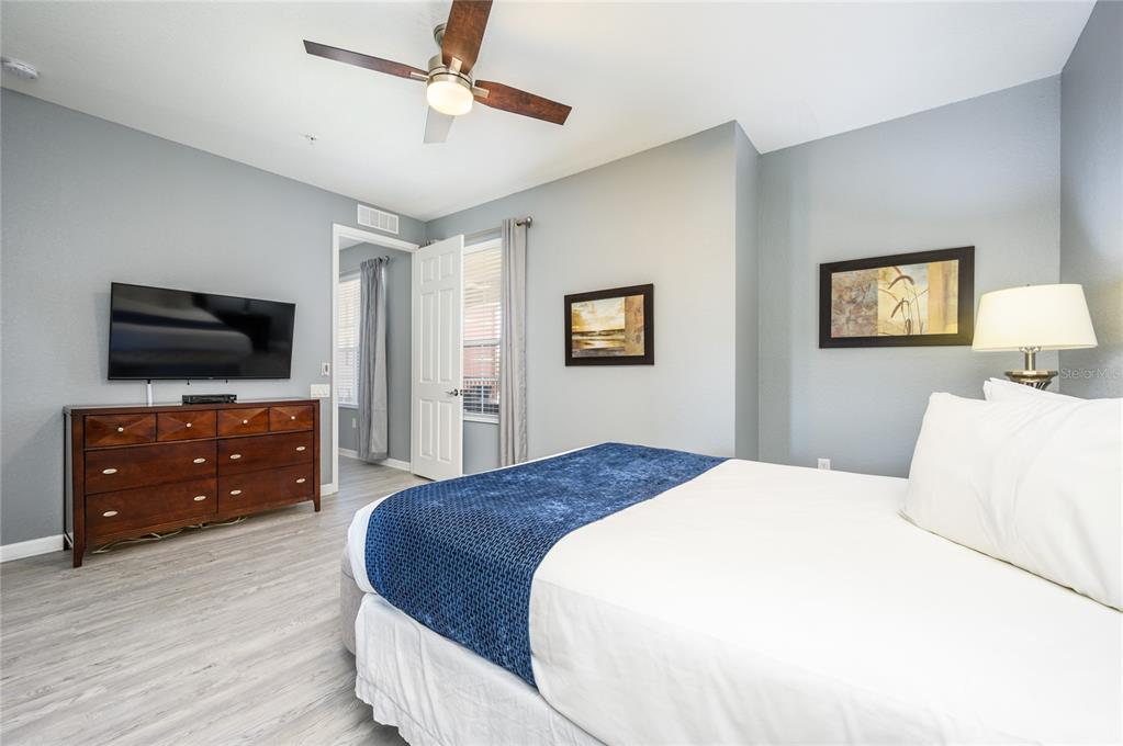 5012 Shoreway Loop, Unit 20507 Orlando, FL 32819 - Photo 18 of 49 a bedroom with a bed and a flat screen tv