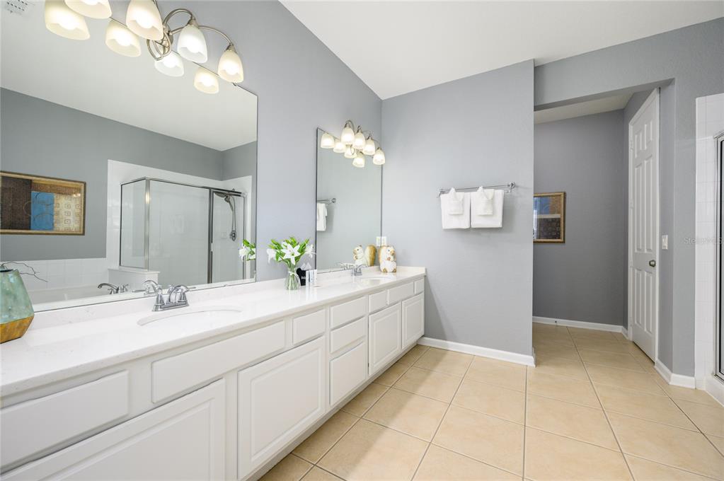 5012 Shoreway Loop, Unit 20507 Orlando, FL 32819 - Photo 21 of 49 a bathroom with a sink a vanity and a mirror
