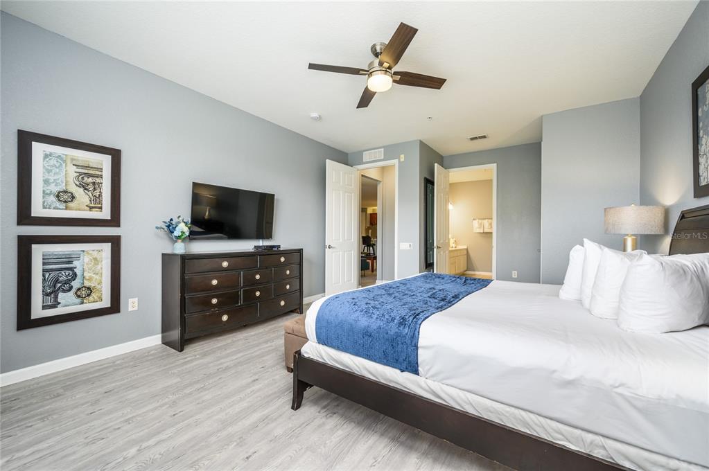 5012 Shoreway Loop, Unit 20507 Orlando, FL 32819 - Photo 23 of 49 a bedroom with a bed and a flat screen tv