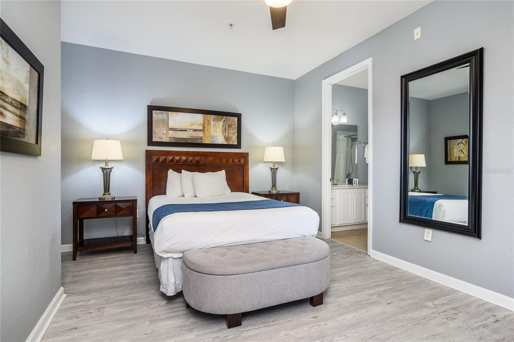5012 Shoreway Loop, Unit 20507 Orlando, FL 32819 - Photo 24 of 49 a spacious bedroom with a bed and a night stand