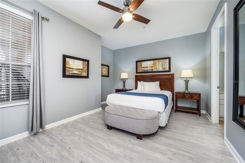 5012 Shoreway Loop, Unit 20507 Orlando, FL 32819 - Photo 25 of 49 a bedroom with a bed and window