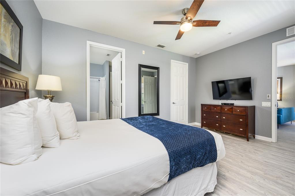 5012 Shoreway Loop, Unit 20507 Orlando, FL 32819 - Photo 26 of 49 a bedroom with a bed and a flat screen tv on dresser