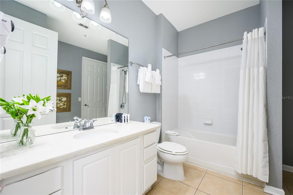 5012 Shoreway Loop, Unit 20507 Orlando, FL 32819 - Photo 27 of 49 a bathroom with a sink a toilet and shower