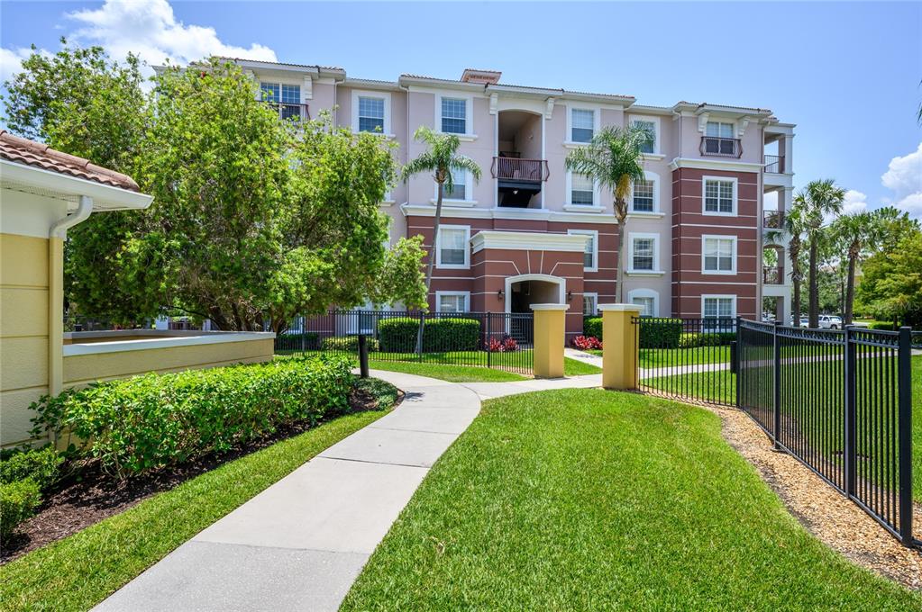 5012 Shoreway Loop, Unit 20507 Orlando, FL 32819 - Photo 3 of 49 a house view with a garden space