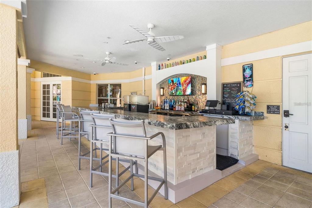 5012 Shoreway Loop, Unit 20507 Orlando, FL 32819 - Photo 36 of 49 a kitchen with stainless steel appliances kitchen island granite countertop a table and chairs in it