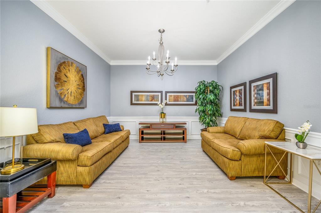 5012 Shoreway Loop, Unit 20507 Orlando, FL 32819 - Photo 7 of 49 a living room with furniture and a chandelier