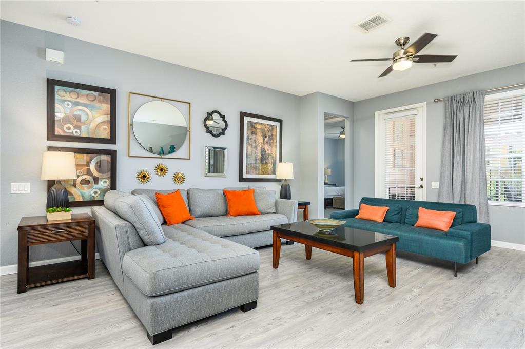 5012 Shoreway Loop, Unit 20507 Orlando, FL 32819 - Photo 9 of 49 a living room with furniture and a large window