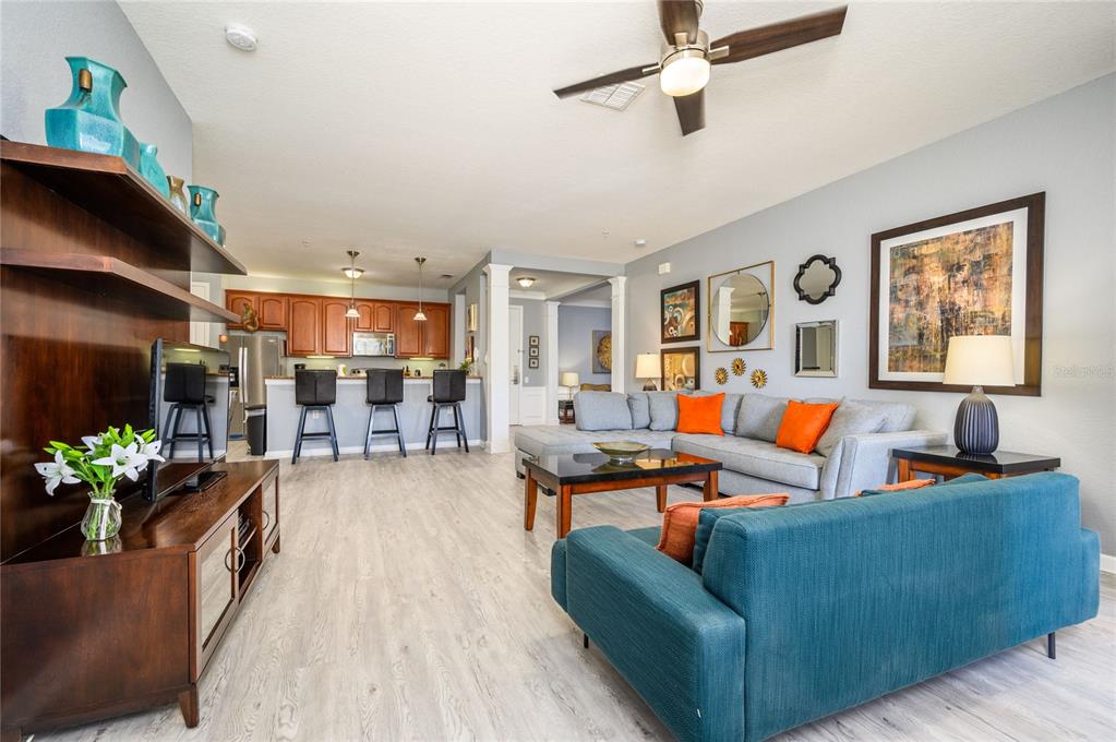 5012 Shoreway Loop, Unit 20507 Orlando, FL 32819 - Photo 10 of 49 a living room with furniture kitchen view and a window