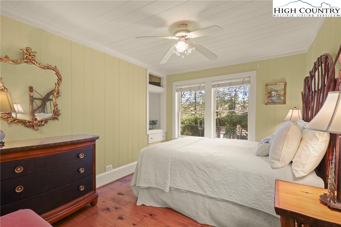 326 Ransom Street Blowing Rock, NC 28605 - Photo 16 of 25 a bedroom with a bed a chandelier and a dresser
