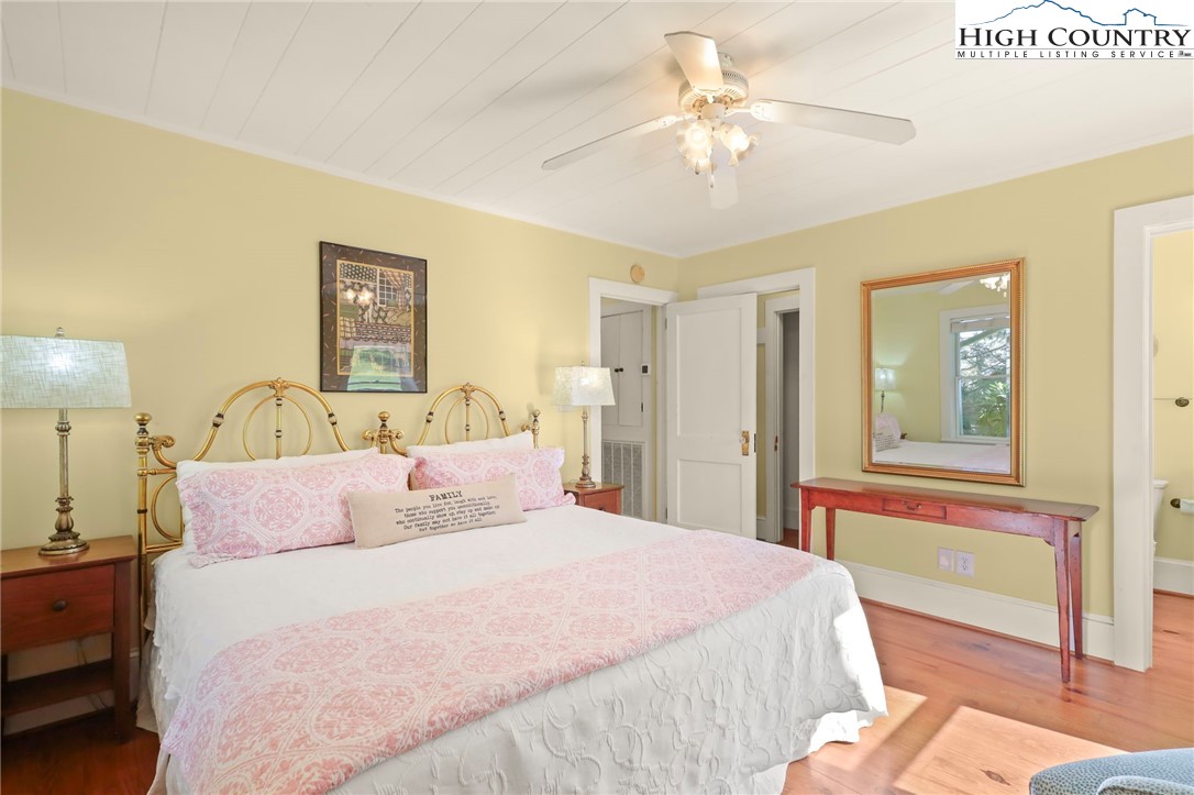 326 Ransom Street Blowing Rock, NC 28605 - Photo 20 of 25 a bedroom with a large bed and a chandelier