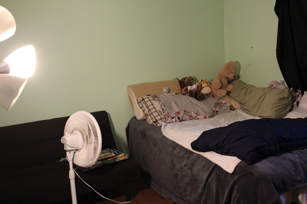 117 Sherbert Road Ashburnham, MA 01430 - Photo 7 of 9 a bedroom with a bed and a chandelier