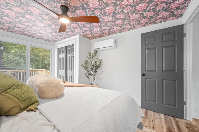 a bedroom with a bed and a chandelier