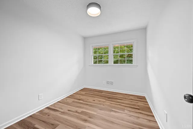 a view of a room with wooden floor and bathroom