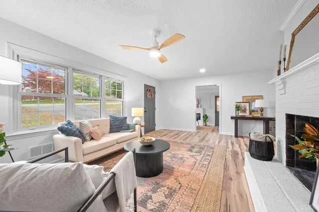 a living room with furniture and a wooden floor