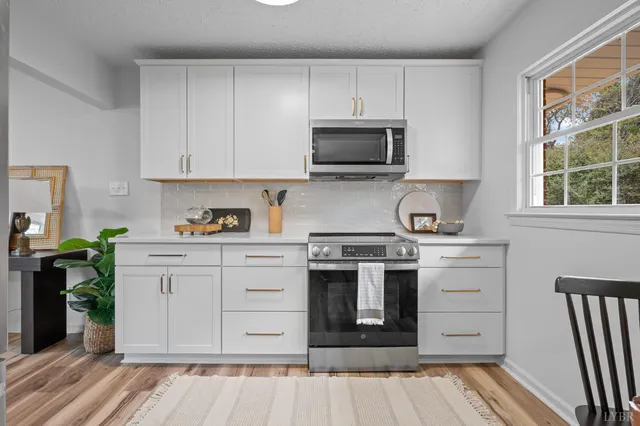 a kitchen with a refrigerator sink and microwave
