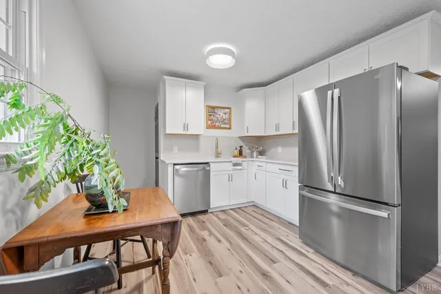 a kitchen with cabinets appliances and a sink