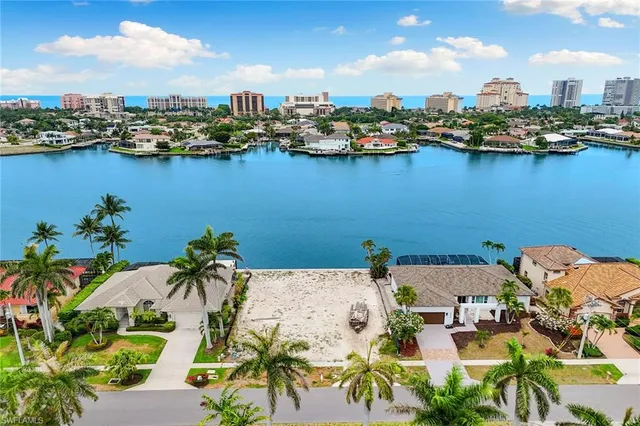 an aerial view of a houses with outdoor space and lake view