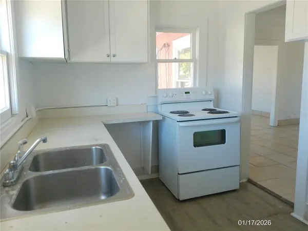 a kitchen that has a sink and a stove