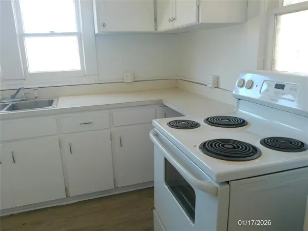 a kitchen with a stove and a microwave
