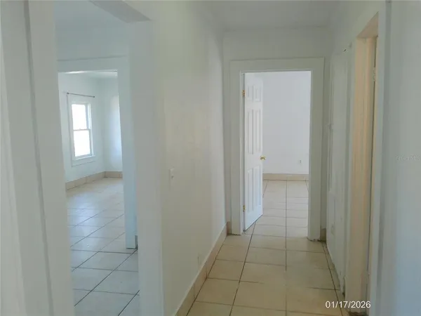 a view of a hallway to rooms