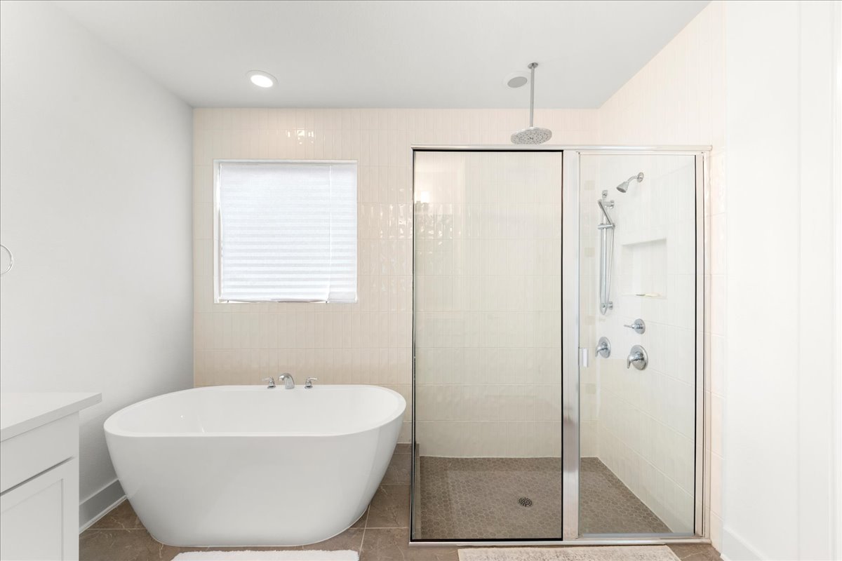 8700 Olmsted Way Austin, TX 78744 - Photo 19 of 40 Bathroom with vanity, a freestanding bath, a shower stall, recessed lighting, and tile patterned floors